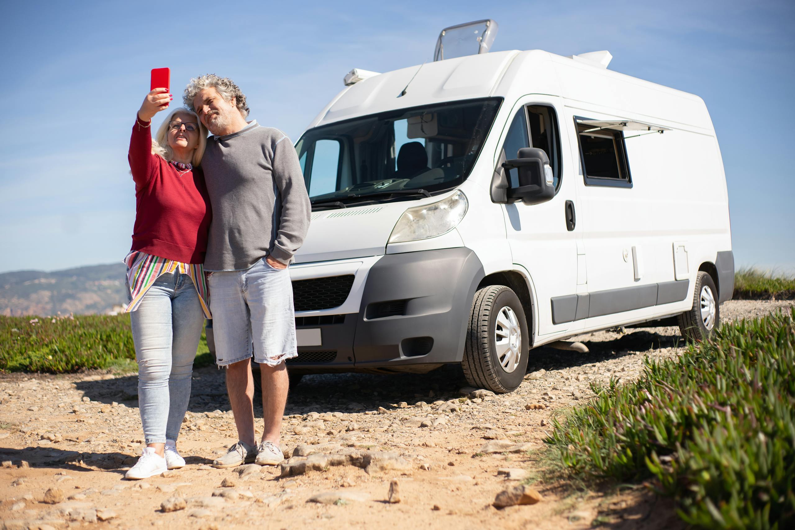 An Elderly Couple Taking a Selfie beside Their campervan new zealand