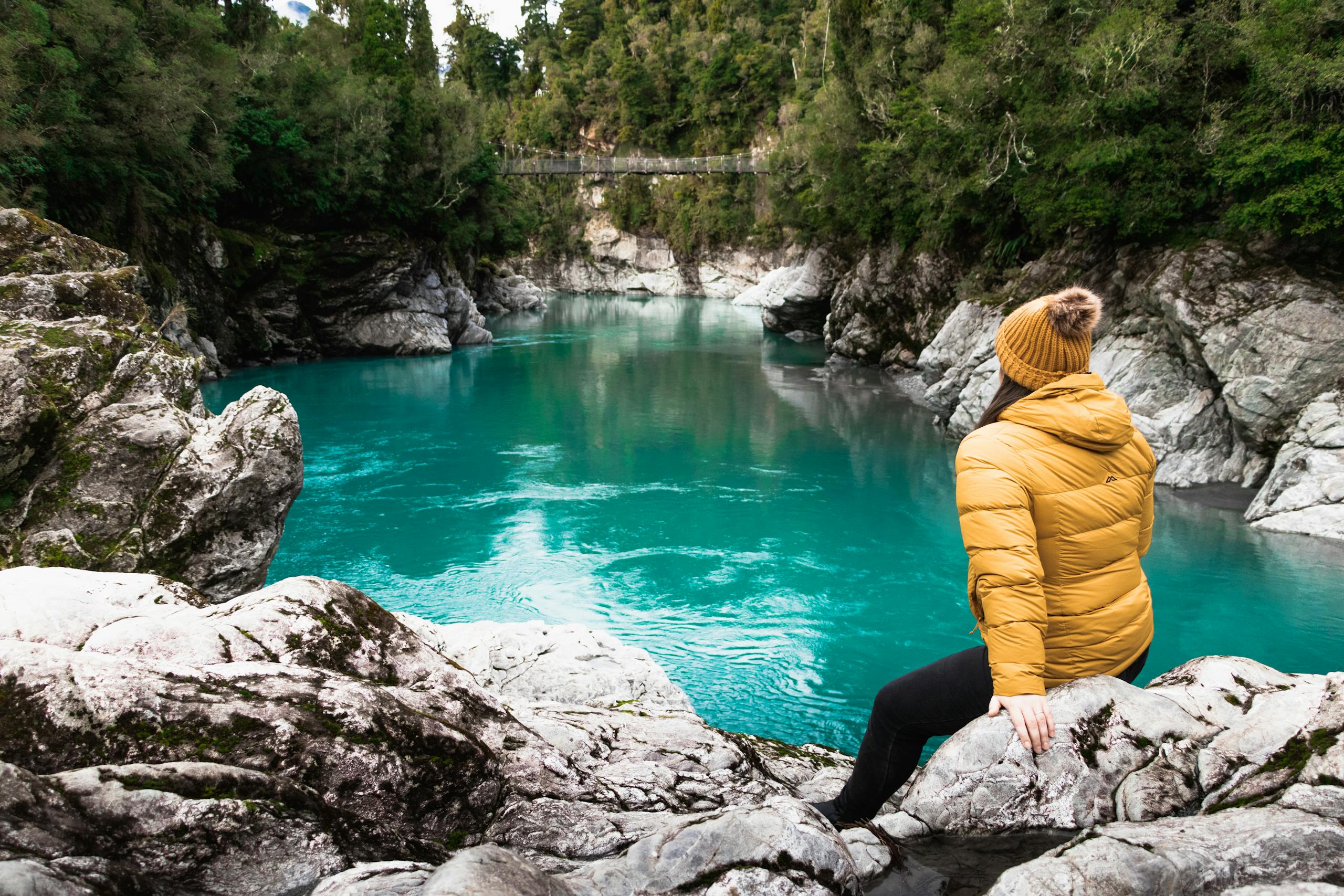 nz sitting by river travel new zealand